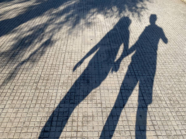 Couple in Shadow Silhouette having a walk near the Pier