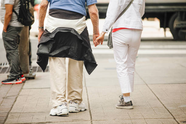 An elderly couple walks through the city holding hands in Philadelphia, Pennsylvania, USA June 10, 2024