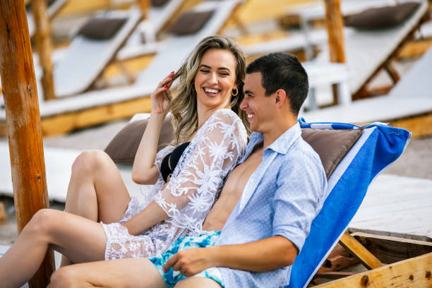 istock Beautiful young couple laying on the beach. 2158138892