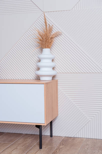 istock A ceramic white vase with a dry plant on a low bedside table 2158139141