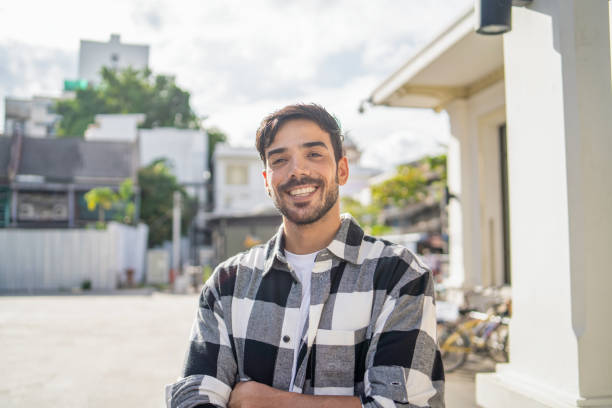 Smiling middle eastern man standing outdoors in city