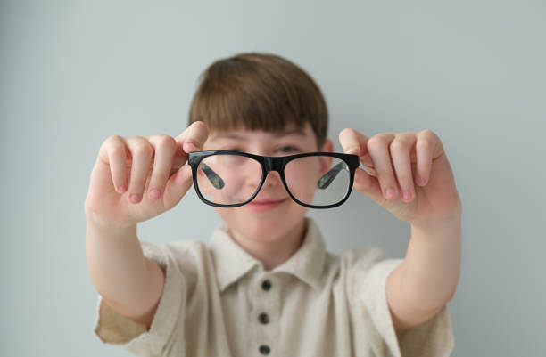Banner little boy with glasses correcting myopia close-up portrait Ophthalmology problem selective focus