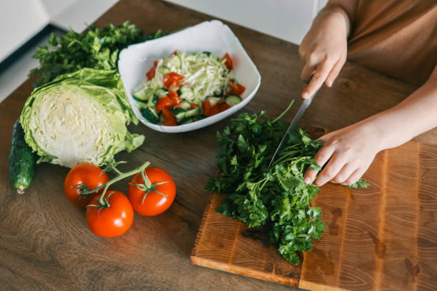 istock Child at table with leaf vegetables, a natural food ingredient 2158144407