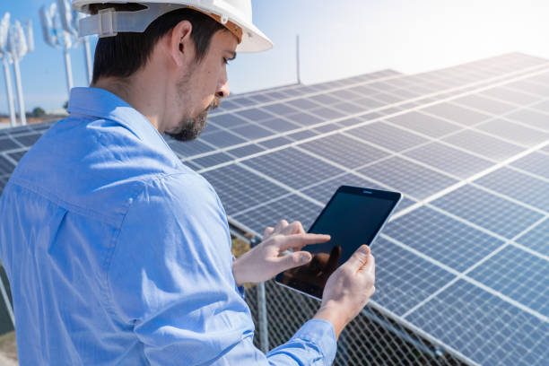istock Engineer with a tablet with photovoltaic solar panel system plant. 2158145881
