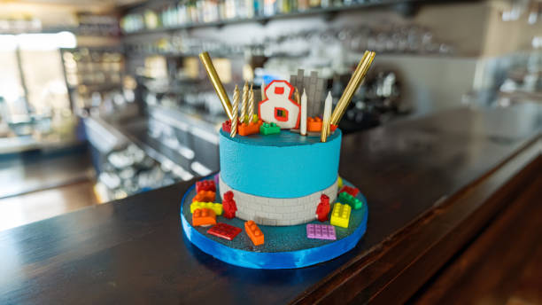 Blue fondant cake with candles and constructor pieces. 8th birthday. Game theme. High quality photo