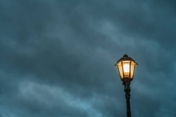 Cloudy evening sky and street lights looking up