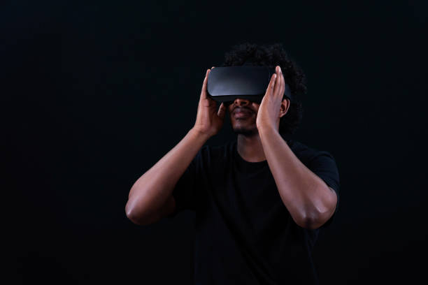 Man in vr glasses, African people, watching 360 degree video with virtual reality headset isolated on black background.