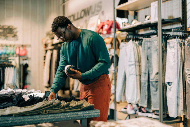 istock Happy retail clerk working at a clothing store 2158156000