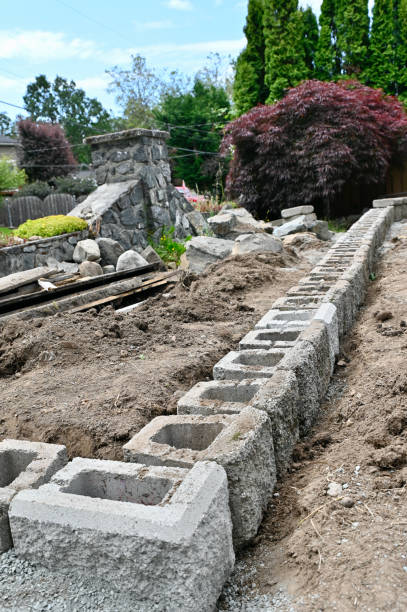 istock Rock wall construction with concrete building blocks for terracing garden, pathways, yard and patios 2158156102