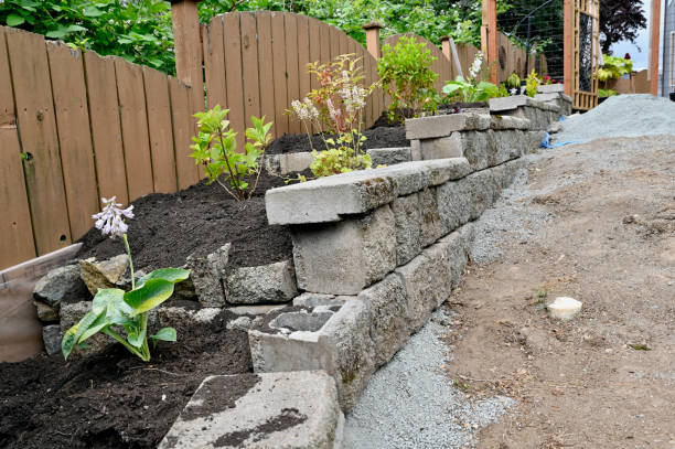 Rock wall construction with concrete building blocks for terracing garden, pathways, yard and patios