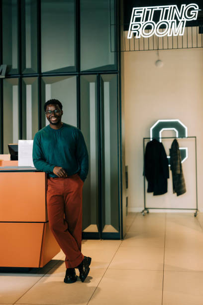 istock Happy retail clerk working at a clothing store 2158156112