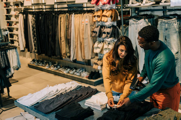 istock Retail Sales Manager Explaining to New Assistant Employee Everything He She Needs to Know About Working at Fashionable Shop with Stylish Brand Designs. 2158156278