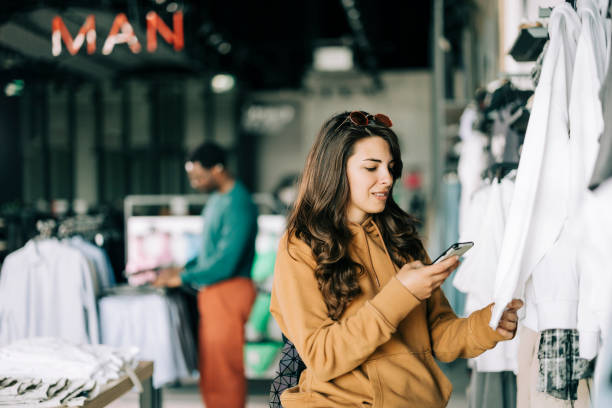 istock Retail Sales Manager Explaining to New Assistant Employee Everything He She Needs to Know About Working at Fashionable Shop with Stylish Brand Designs. 2158156346