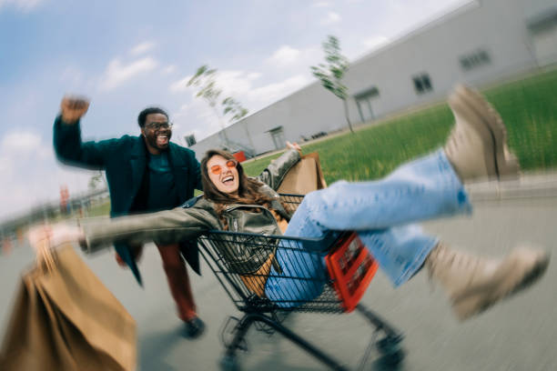 istock Happy couple riding shopping trolley 2158156369
