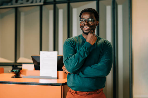 istock Happy retail clerk working at a clothing store 2158156411