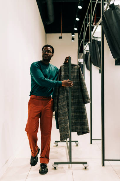 istock Happy retail clerk working at a clothing store 2158156494