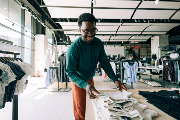 istock Happy retail clerk working at a clothing store 2158156636