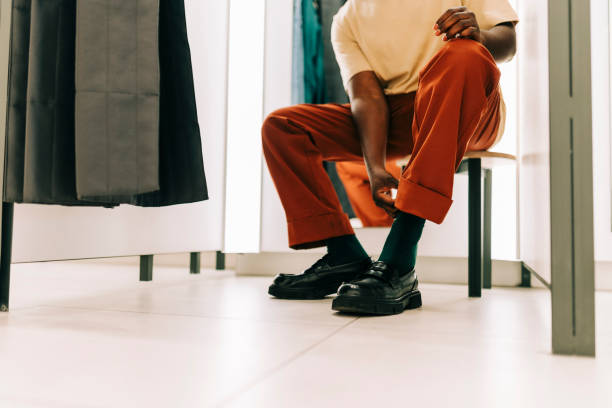 istock Close up of man sitting in fitting room 2158156750