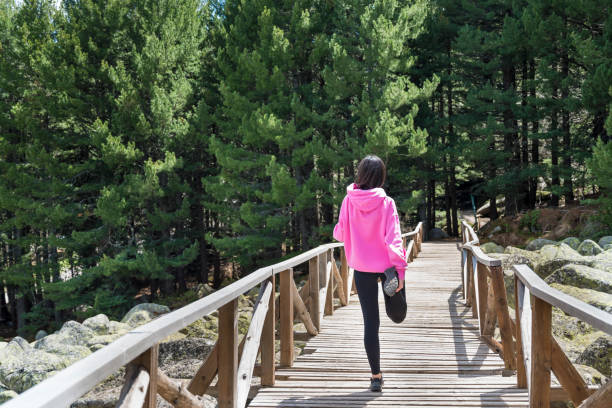 istock Young woman stretching  after jogging in the mountain 2158157635