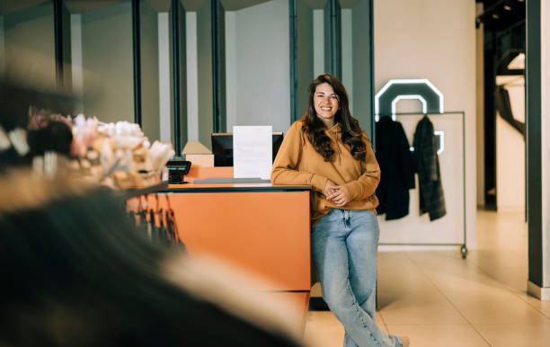 istock Small business owner smiling cheerfully in her shop. 2158157758