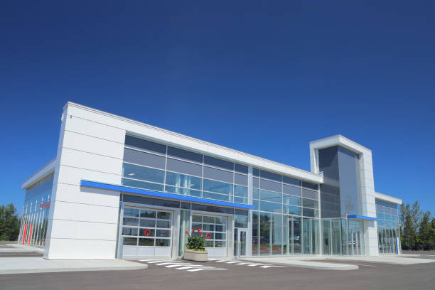 Modern Car Dealership Garage Building with Copy Space in a Clear Blue Sky