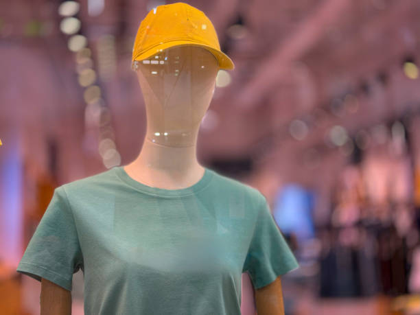 Fashion model mannequin with light Summer hat, Full brim. The mannequin's face is femine, looking to the side.