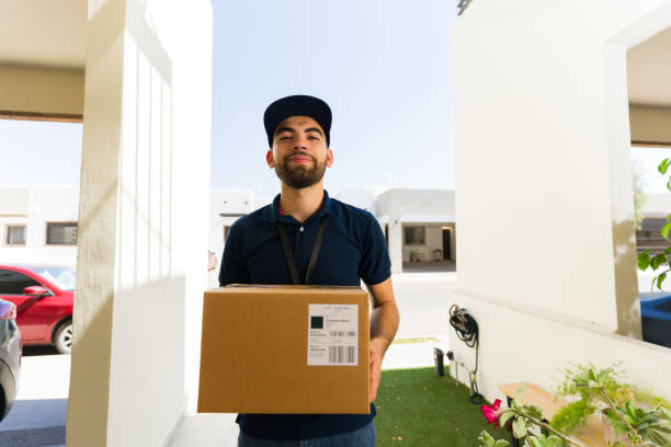 Security camera captures young delivery man with package at suburban house doorstep