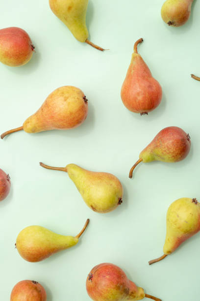 istock Fruit pattern of pears on a green background. Summer aesthetic food concept. 2158165081