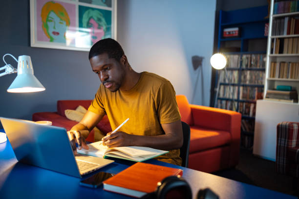 istock African American student studies at home at night 2158169469