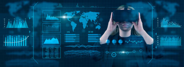 istock Young businesswoman using VR glasses with digital media interface. She’s working on a new project. She looks very busy. Blue hologram. Analytics. Virtual reality technologies for education GUI (Graphical User Interface) concept 2158172324