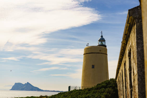 istock Lighthouse and Gibraltar rock, La Alcaidesa, Spain. 2158175712