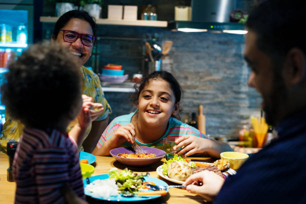 istock Family eating at the dining table together 2158175748
