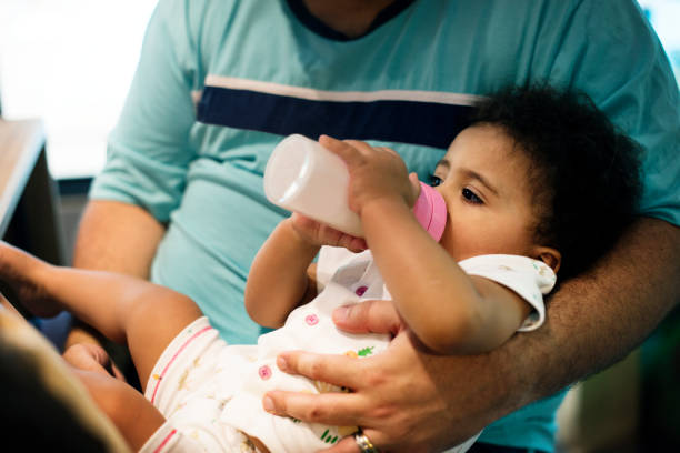 istock Little girl feeding from formula bottle 2158175754