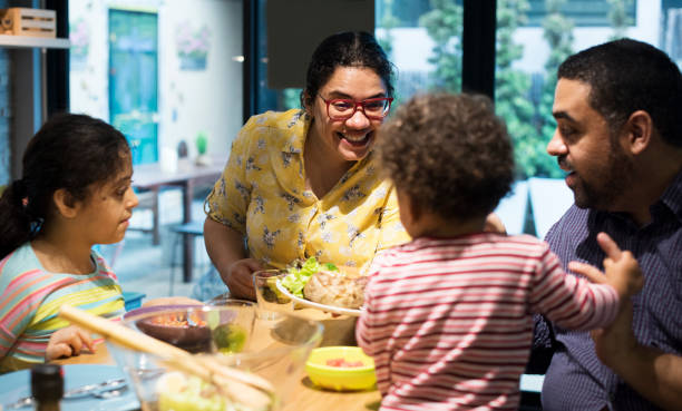 istock Family eating at the dining table together 2158175783