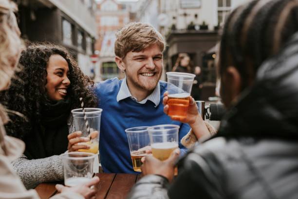 istock Diverse friends celebrating in pub, drinking beer 2158176035