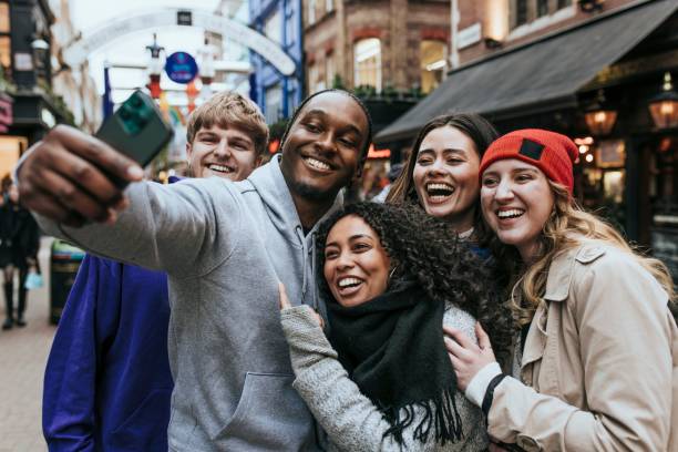 istock Diverse people taking photos together in city 2158176214