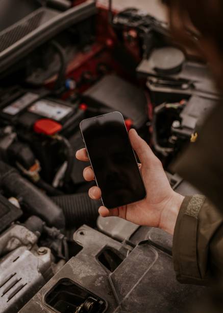 istock Man with broken car, holding phone photo 2158176284