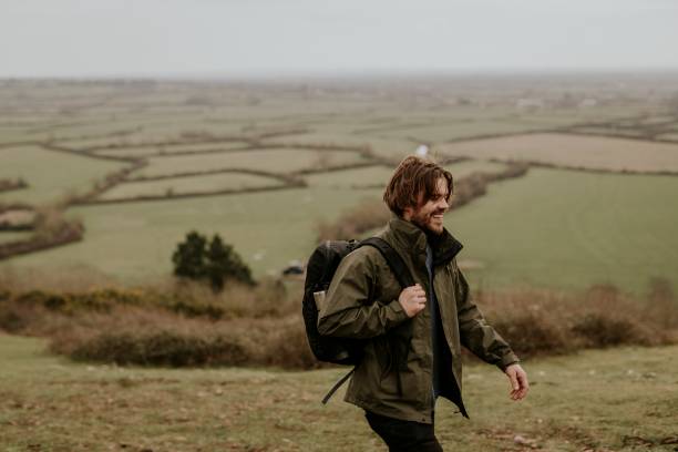 istock Smiling male hiker walking on hill 2158176370