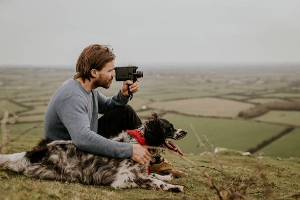 istock Man & dog sitting on hill photo 2158176403