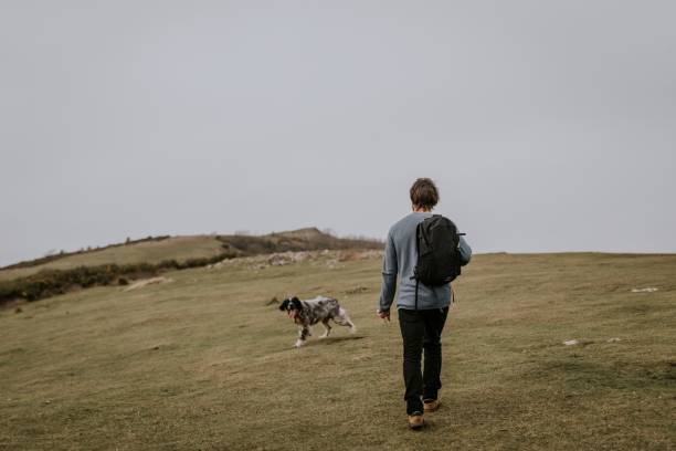 istock Man walking dog on hill photo 2158176455
