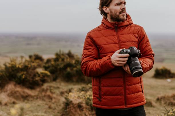 istock Photographer holding camera, nature photography 2158176475