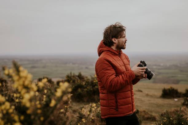 istock Photographer holding camera, nature photography 2158176476