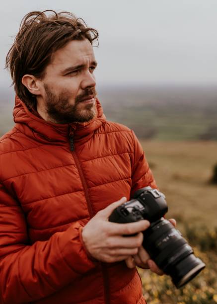 istock Photographer holding camera, nature photography 2158176565