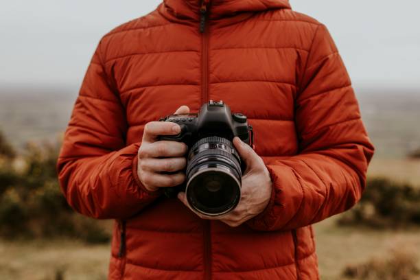 istock Photographer holding camera, nature photography 2158176599