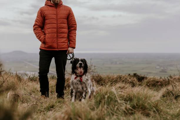 istock Man walking dog on hill photo 2158176896