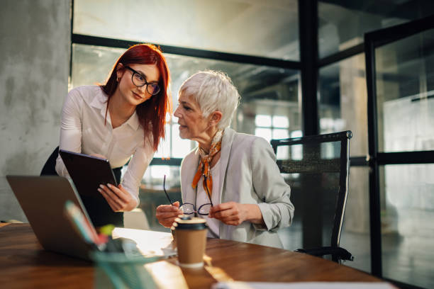 istock Professional female managers with tablet working on business strategy. 2158177320