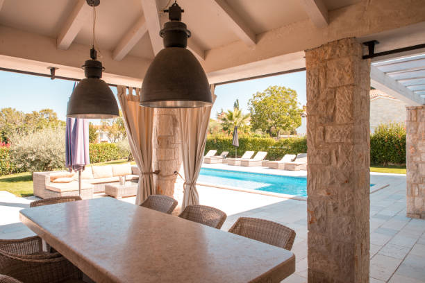 istock Long Table With Stone Tabletop and Wicker Chairs on a Huge Patio 2158178879