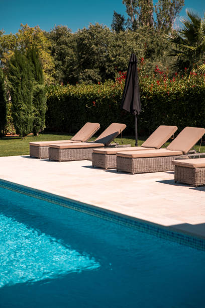 istock Deep Pool and Wicker Sunbeds on Stone Patio 2158178880