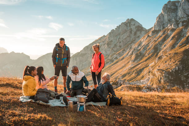istock Refreshing Tea Break on Hilltop with Diverse Group Trekking with Backpacks 2158179000