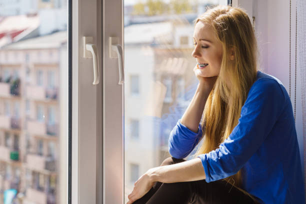 istock Girl on window enjoying sunny day 2158179850